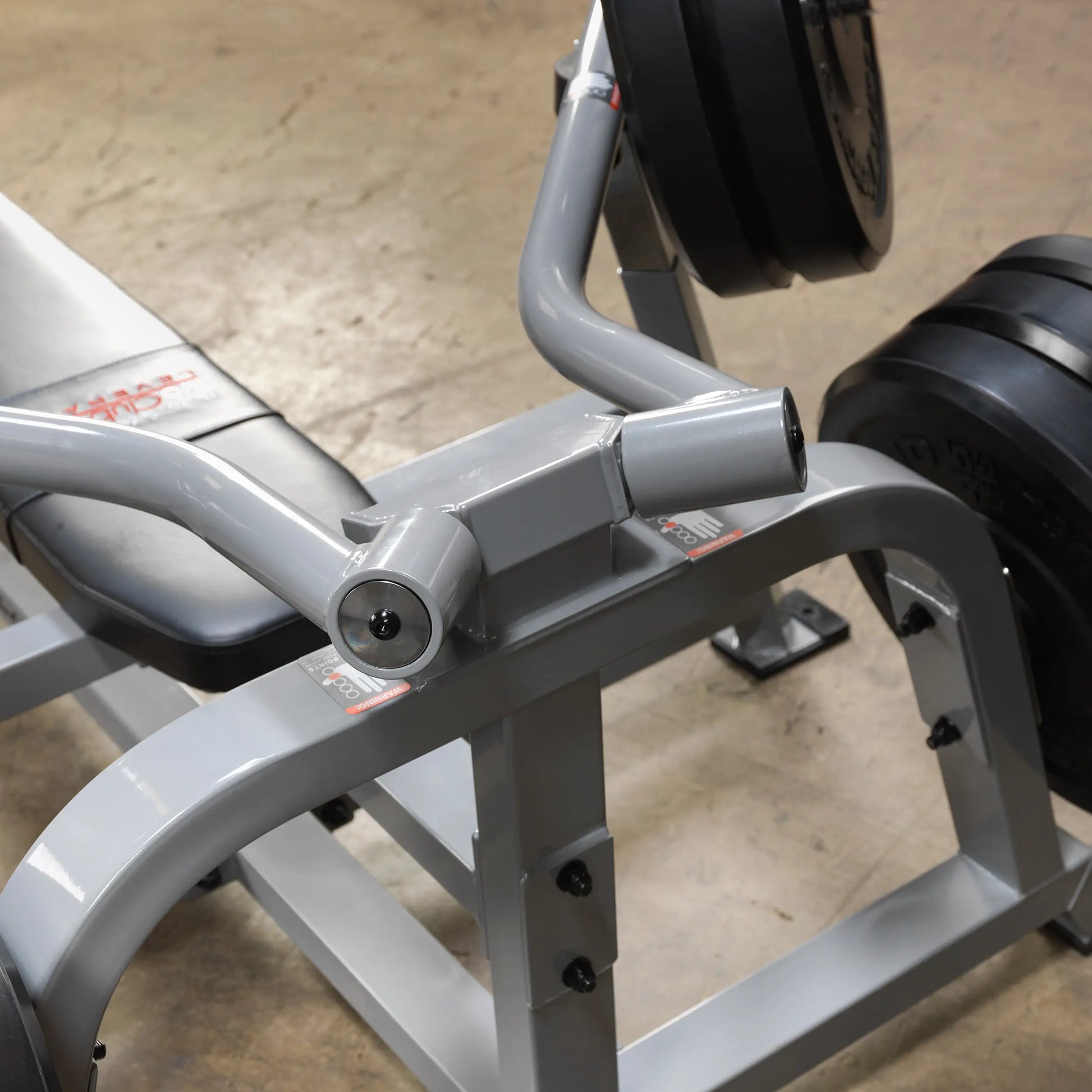 Close-up view of the Body-Solid Pro ClubLine Leverage Bench Press LVBP, showcasing the bench and weight plates in a gym setting.