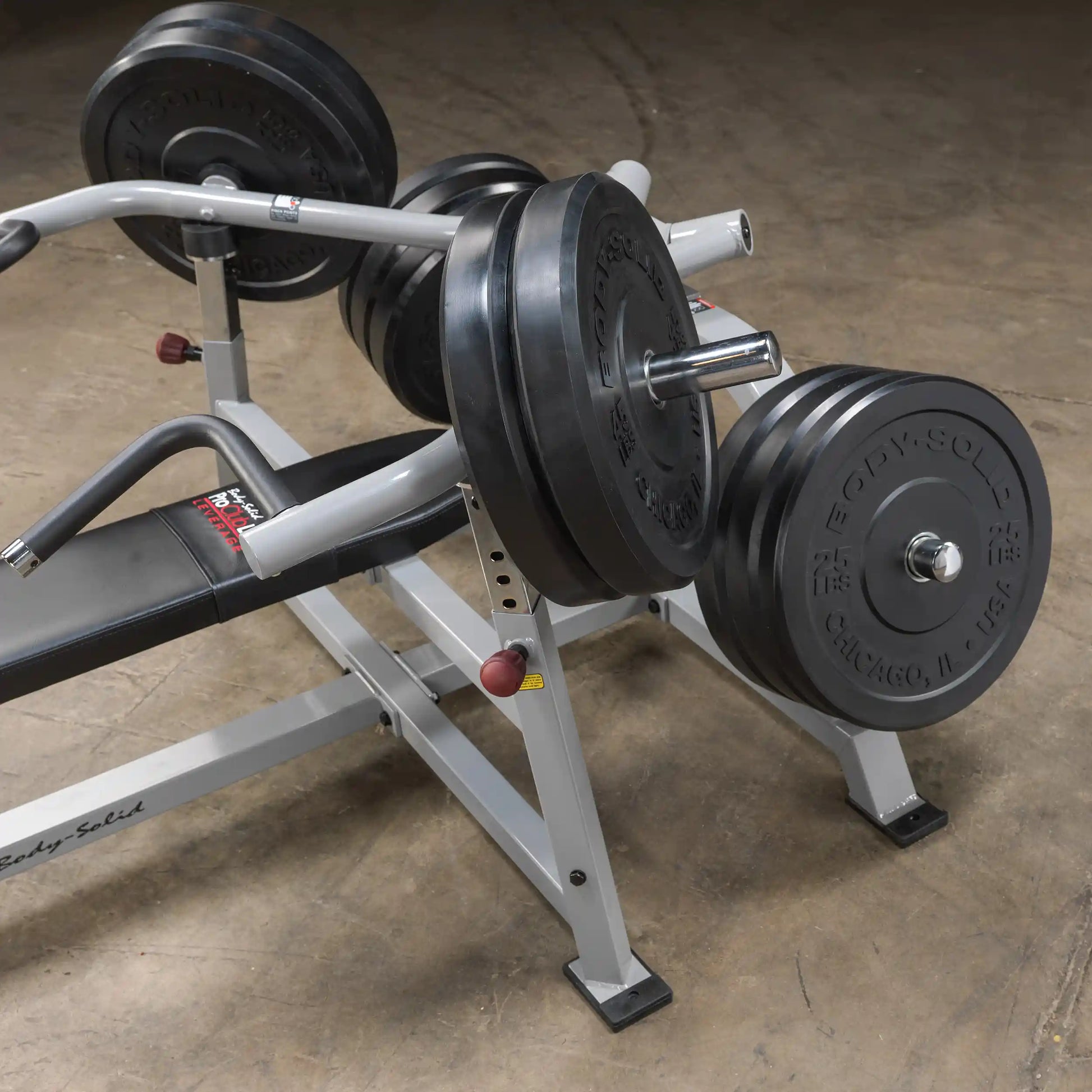 Body-Solid Pro ClubLine Leverage Bench Press LVBP with weight plates on the bar, showcasing the bench press setup in a gym environment.