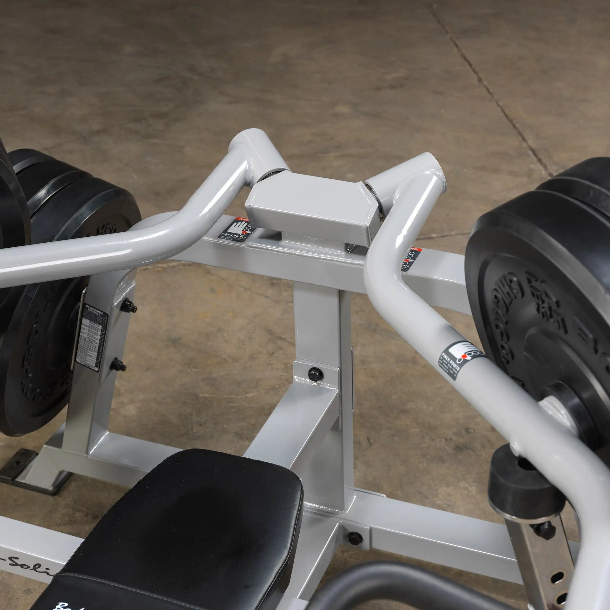 Close-up view of the Body-Solid Pro ClubLine Leverage Bench Press LVBP, showcasing the padded seat and weight plates on either side.