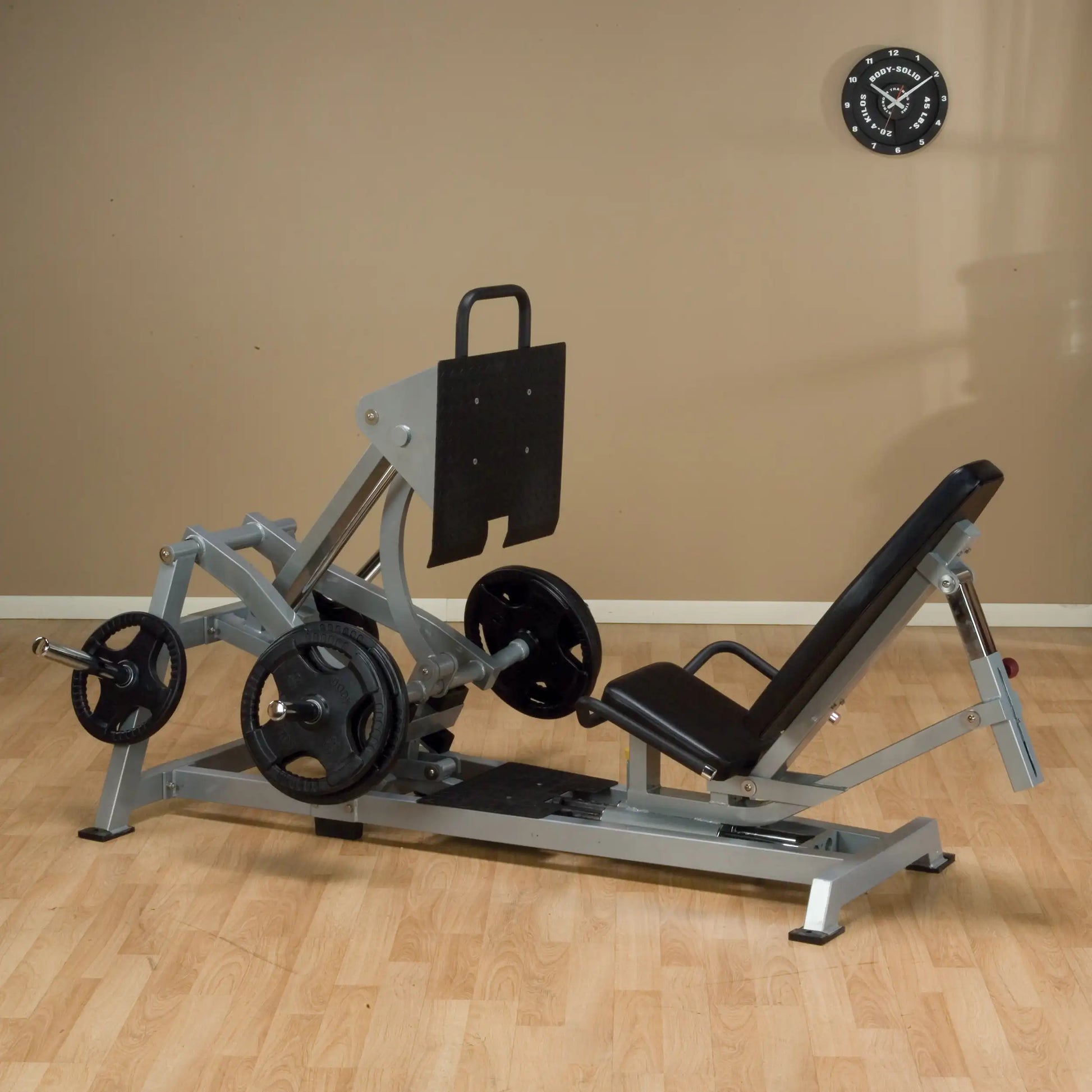 Body-Solid Pro ClubLine Leverage Horizontal Leg Press Machine LVLP positioned in a fitness space, featuring adjustable seat and weight plates.