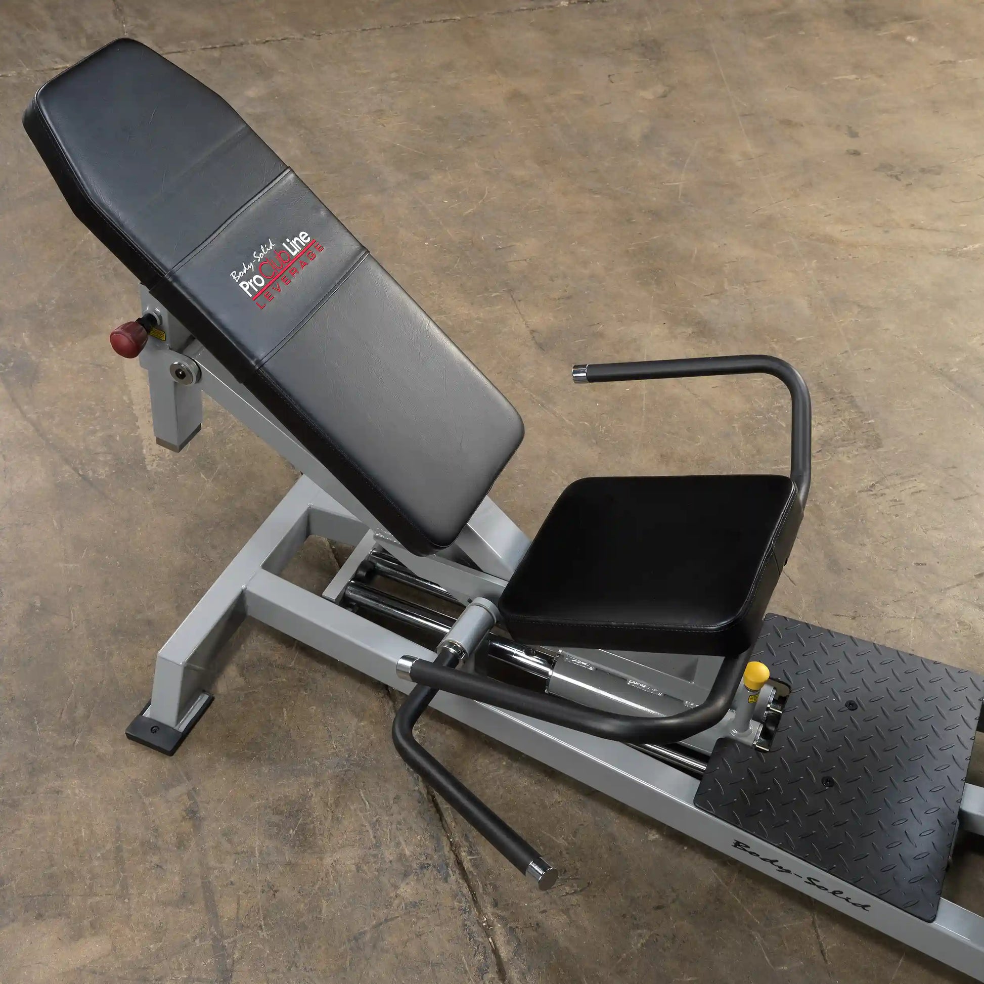 Body-Solid Pro ClubLine Leverage Horizontal Leg Press Machine LVLP, featuring a padded seat and backrest, adjustable arm handles, and a sturdy base on a textured platform.