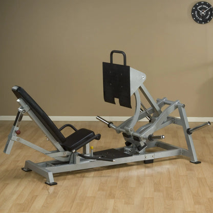 Body-Solid Pro ClubLine Leverage Horizontal Leg Press Machine LVLP on a wooden floor with a plain wall in the background.