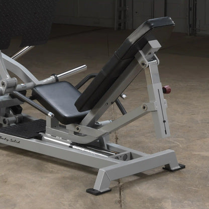 Body-Solid Pro ClubLine Leverage Horizontal Leg Press Machine LVLP, featuring a padded adjustable seat and sturdy metal frame, positioned on a concrete floor.