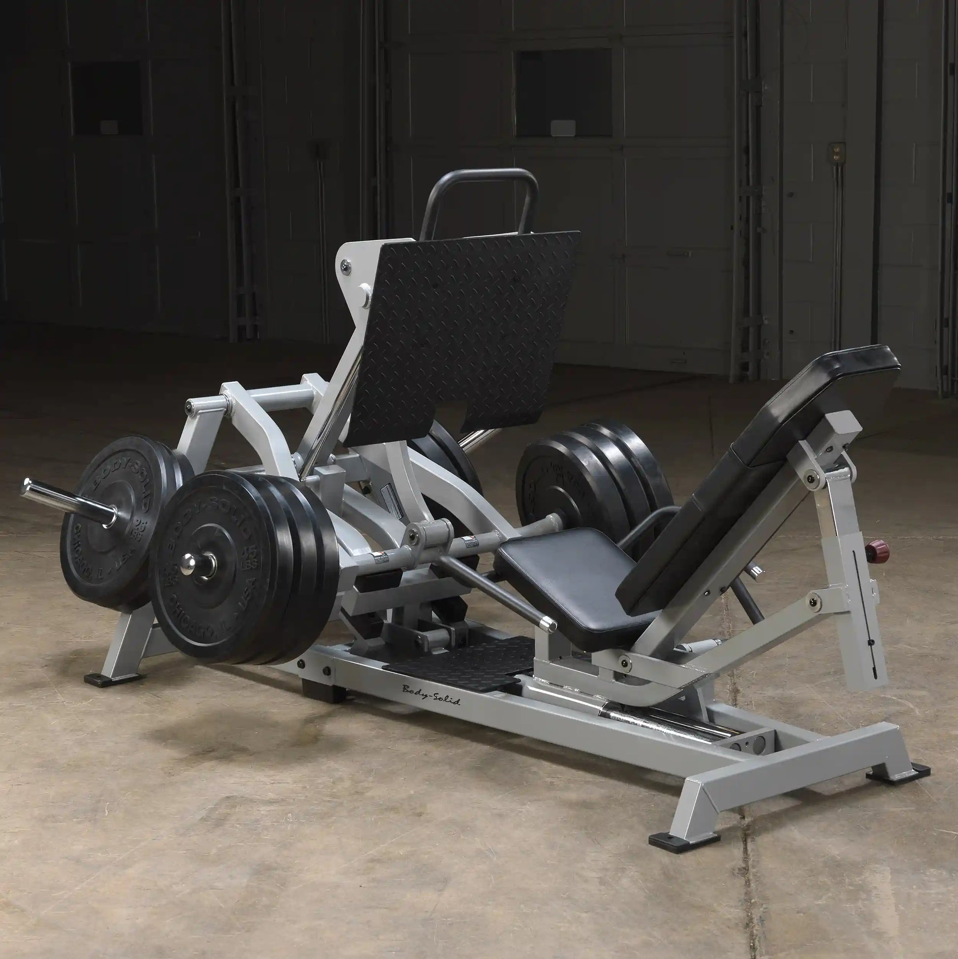 Body-Solid Pro ClubLine Leverage Horizontal Leg Press Machine LVLP, featuring a sturdy design with weight plates, a padded seat, and a back support in a gym setting.