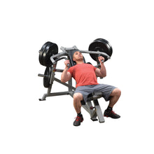Man using the Body-Solid Pro ClubLine Leverage Incline Press LVIP for strength training, positioned on a weight bench with weights on the machine.