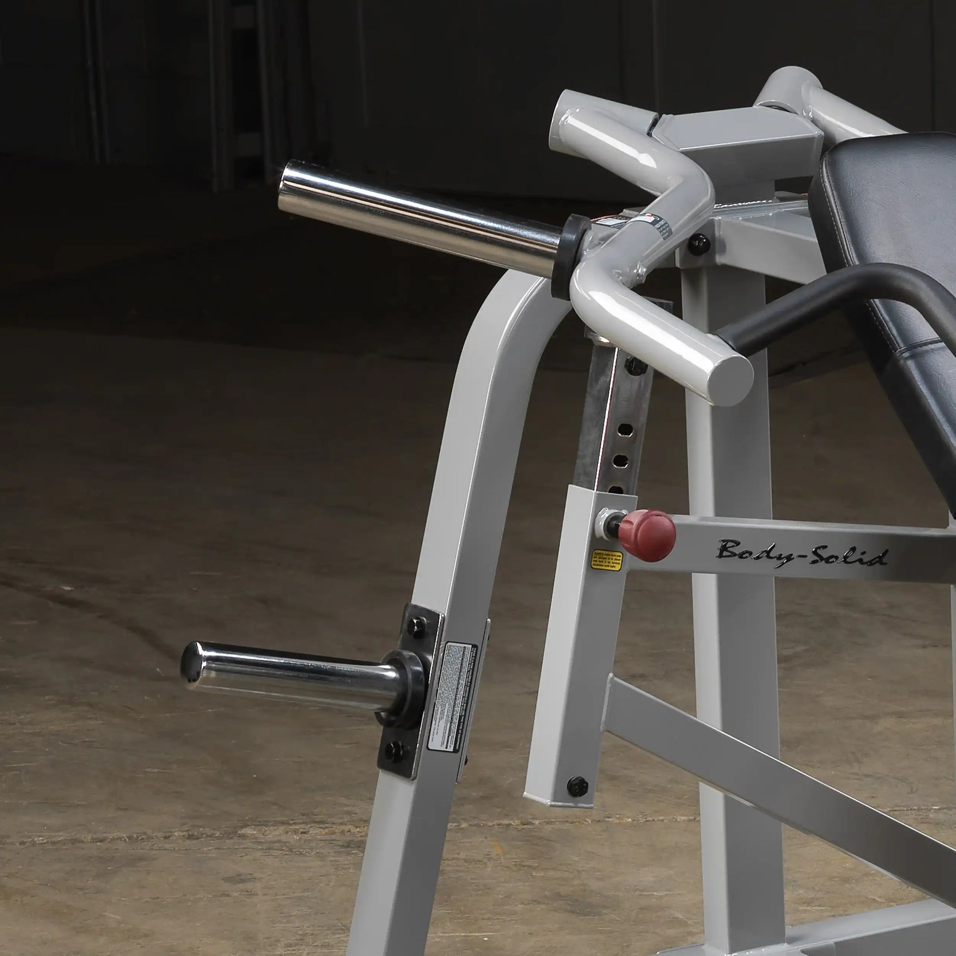 Close-up of the Body-Solid Pro ClubLine Leverage Incline Press LVIP, featuring metallic handles and an adjustable seat, set against a neutral background.