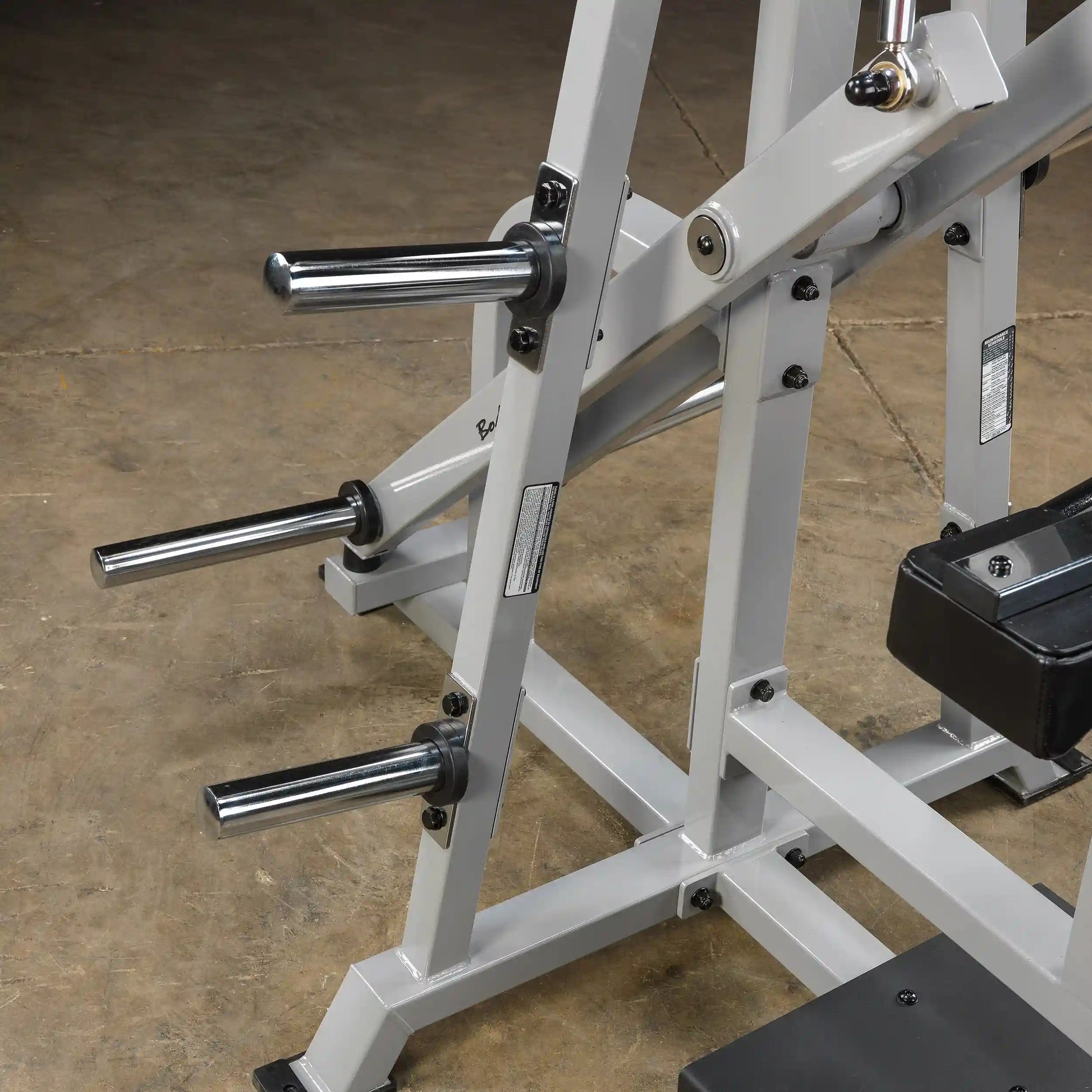 Close-up view of the Body-Solid Pro ClubLine Leverage Lat Pulldown Machine LVLA, featuring chrome weight pegs and a sturdy frame.