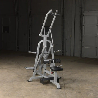 Body-Solid Pro ClubLine Leverage Lat Pulldown Machine LVLA positioned in a dimly lit space, showcasing its sturdy design and adjustable components.