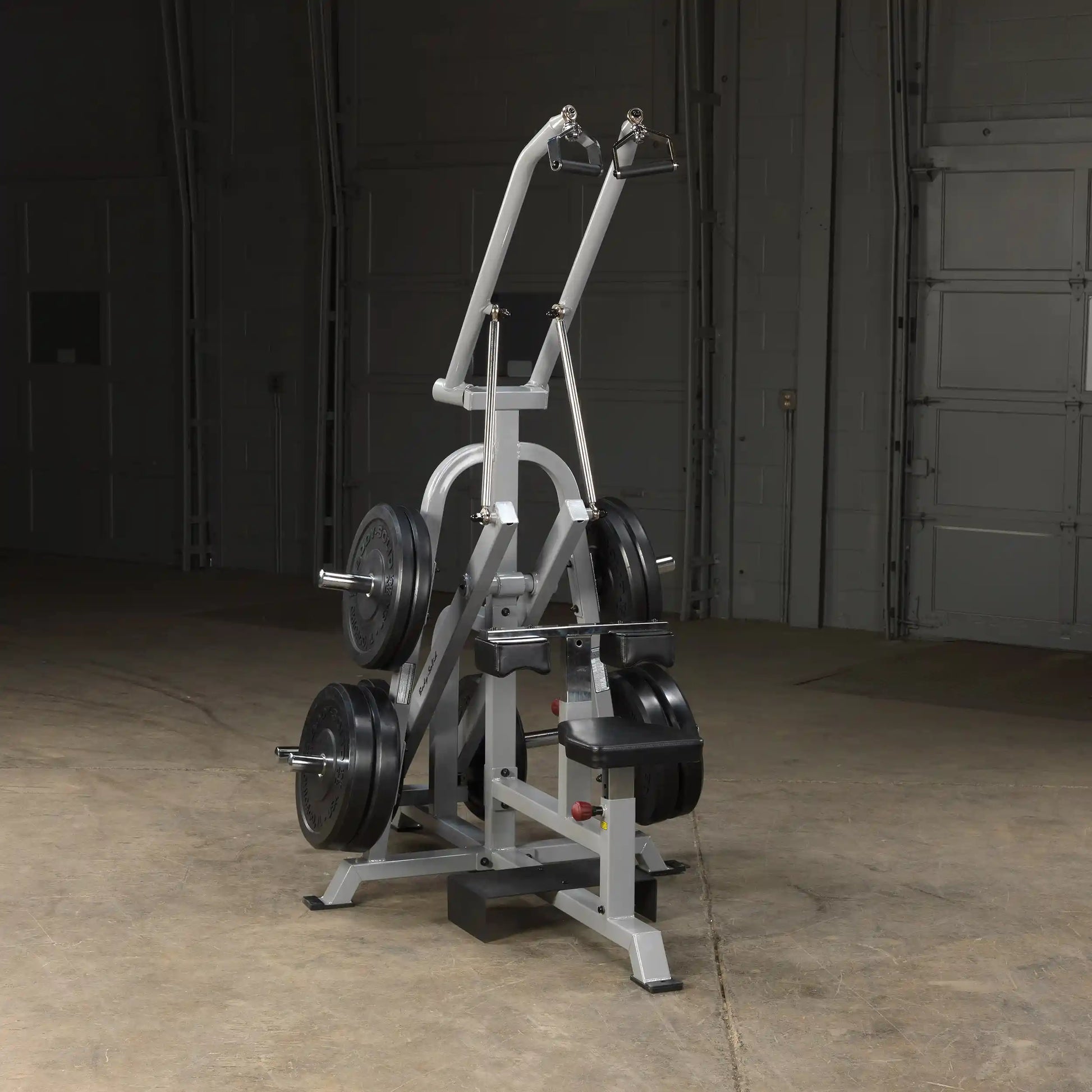 Body-Solid Pro ClubLine Leverage Lat Pulldown Machine LVLA, featuring adjustable arms and weights, positioned in a spacious gym area.