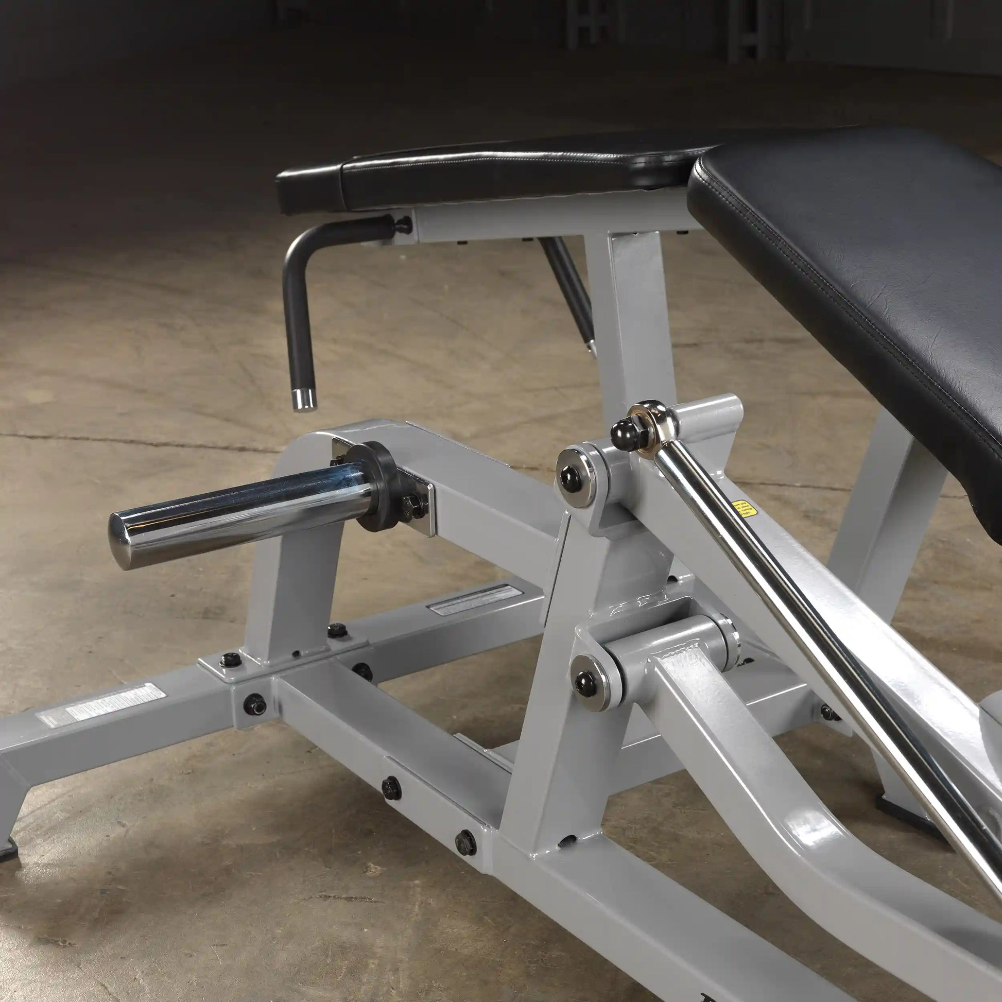 Close-up view of the Body-Solid Pro ClubLine Leverage Leg Curl Machine LVLC, showcasing its adjustable components and sturdy construction.