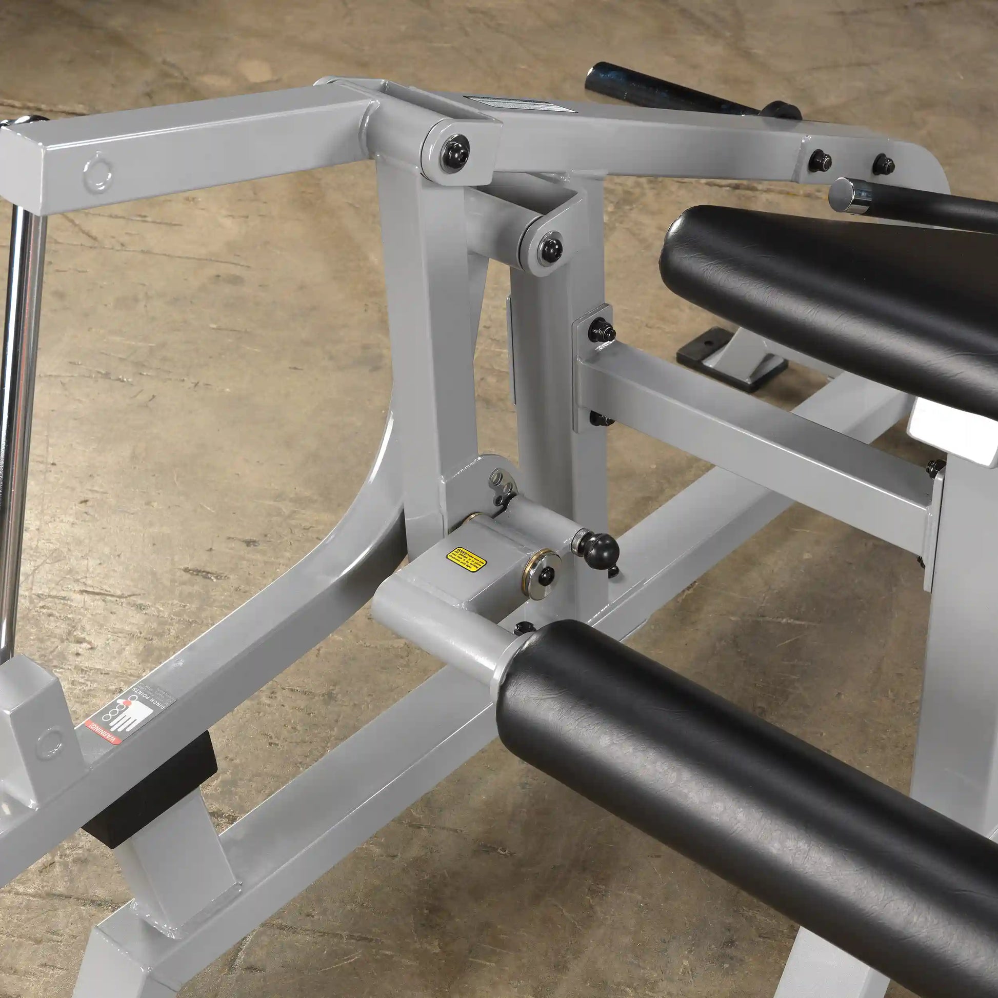 Close-up view of the Body-Solid Pro ClubLine Leverage Leg Extension Machine LVLE, showcasing the adjustable components and padded leg support.