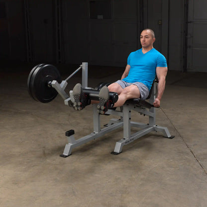 A person using the Body-Solid Pro ClubLine Leverage Leg Extension Machine LVLE in a gym setting, demonstrating leg extension exercises.