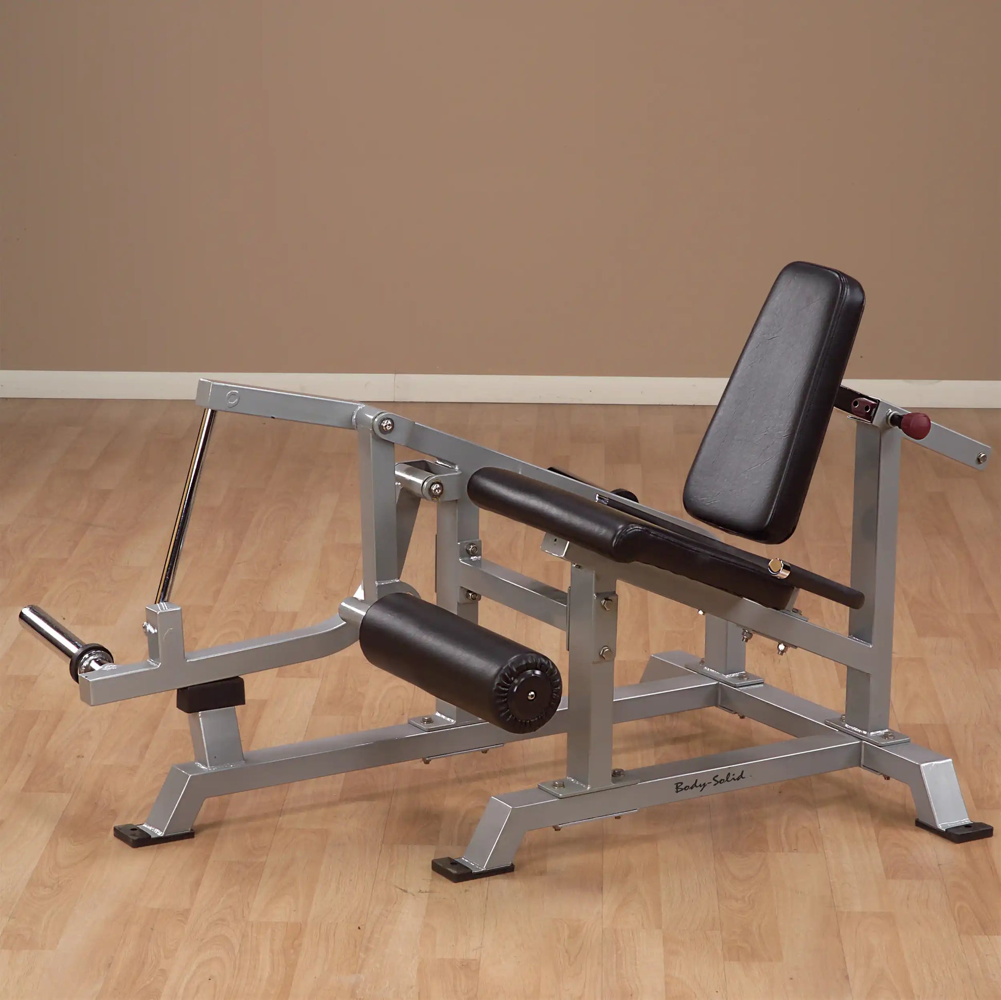 Body-Solid Pro ClubLine Leverage Leg Extension Machine LVLE on a wooden floor with a neutral background.