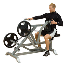 A person using the Body-Solid Pro ClubLine Leverage Seated Row Machine LVSR, demonstrating proper form while seated and pulling the handles toward them.