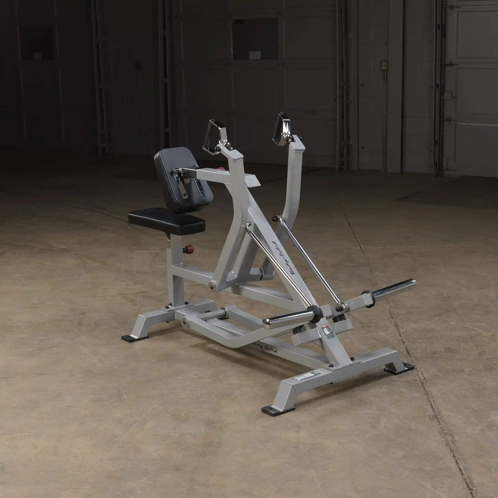 Body-Solid Pro ClubLine Leverage Seated Row Machine LVSR positioned in a spacious gym environment with a concrete floor and dim lighting.