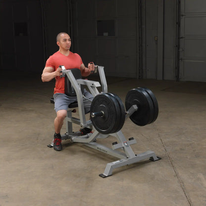 A person using the Body-Solid Pro ClubLine Leverage Seated Row Machine LVSR in a gym setting, demonstrating proper form while performing a seated row exercise.