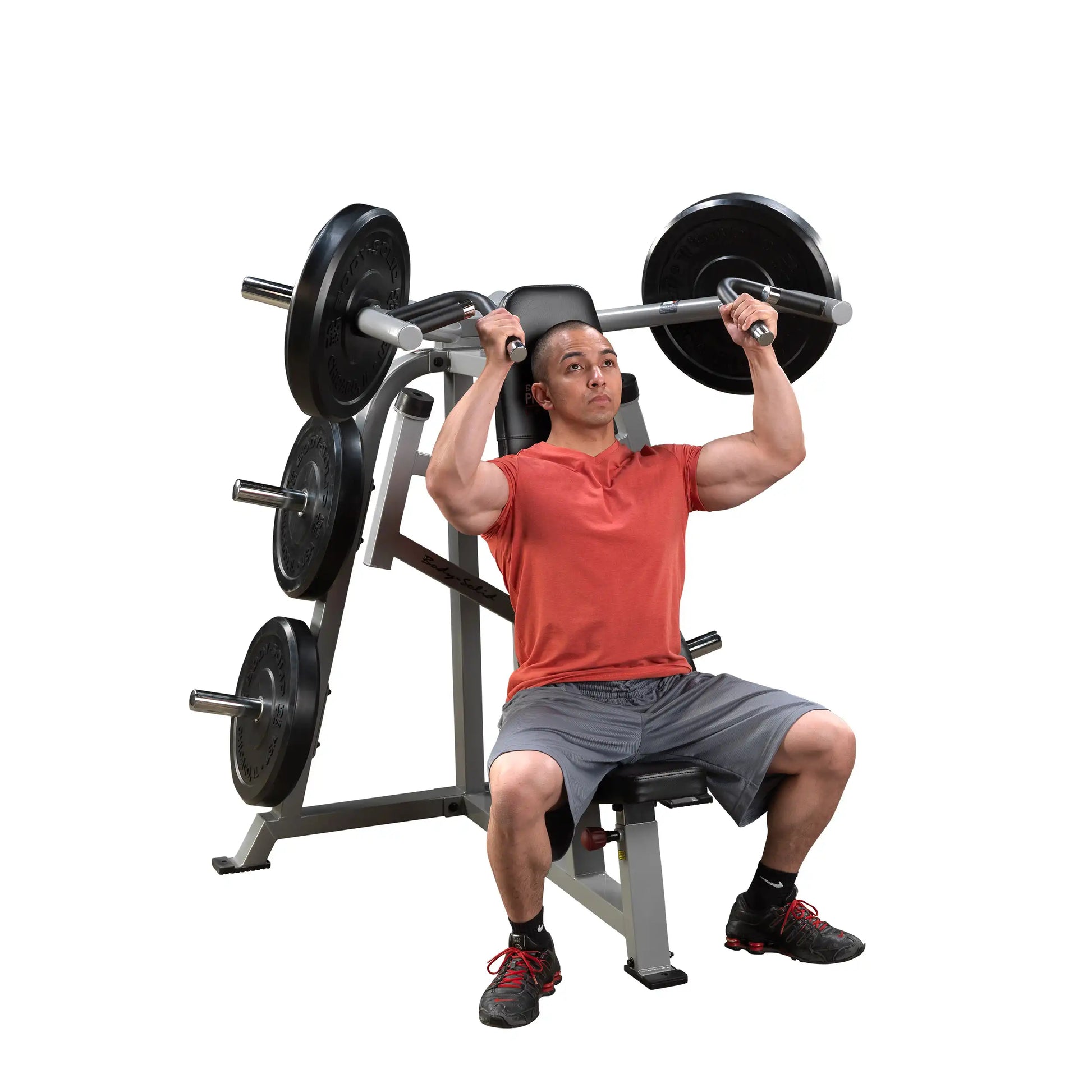 A man performing an overhead press on the Body-Solid Pro ClubLine Leverage Shoulder Press Machine LVSP, showcasing strength training with weights on the machine.