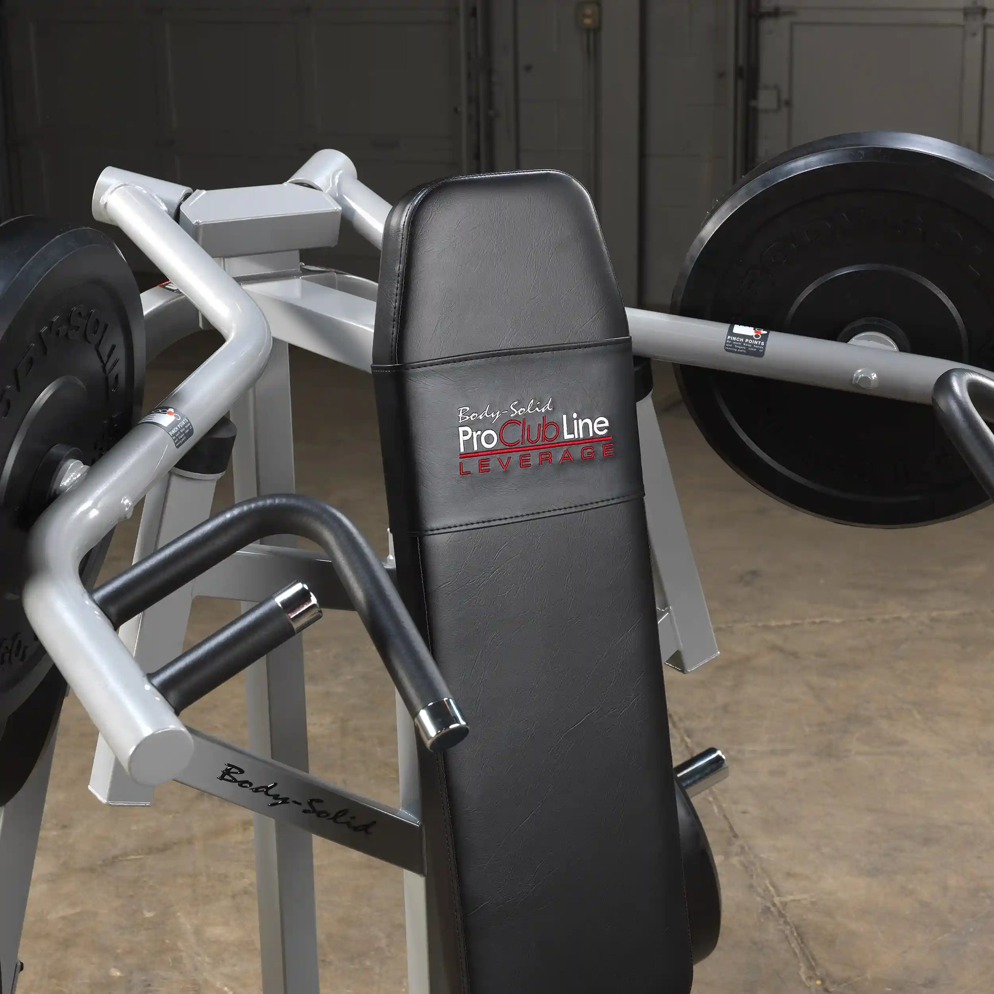 Close-up of the Body-Solid Pro ClubLine Leverage Shoulder Press Machine LVSP, featuring a padded seat and handles, set against a neutral background.