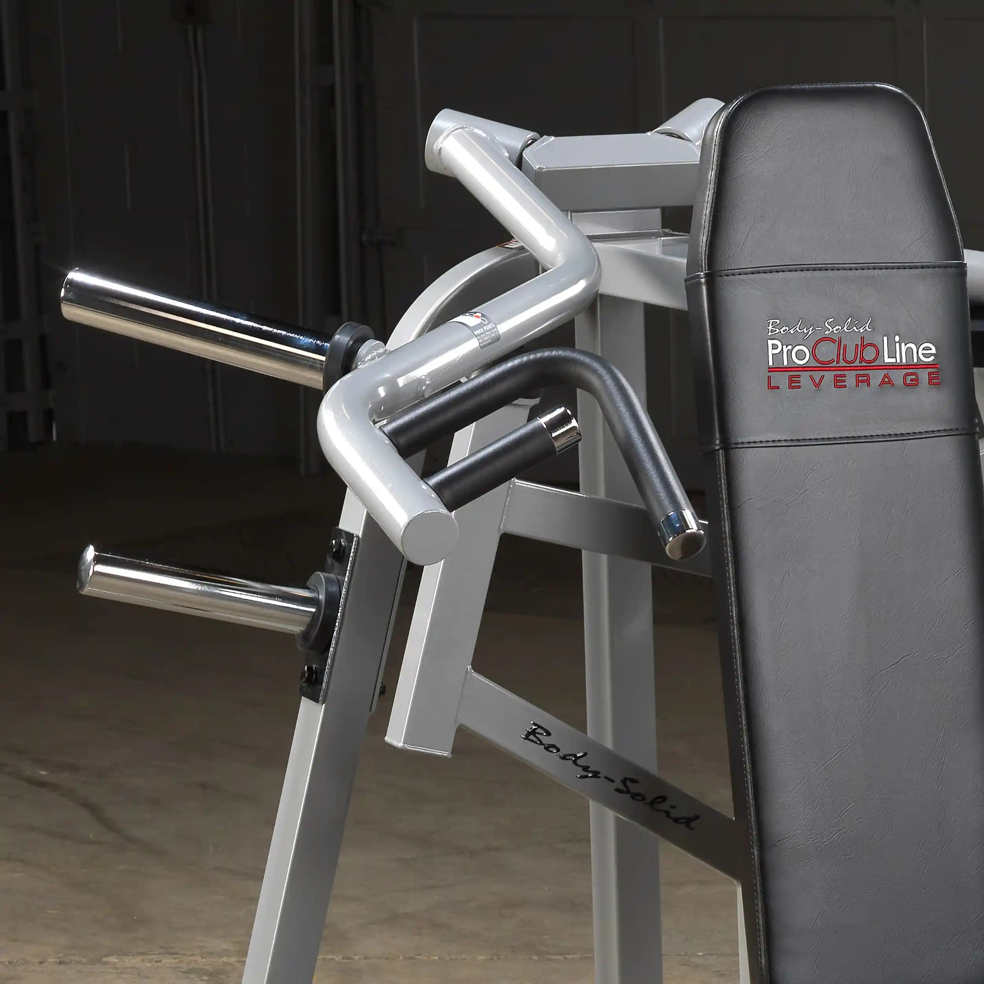 Close-up view of the Body-Solid Pro ClubLine Leverage Shoulder Press Machine LVSP, showcasing its ergonomic handles and padded seat.