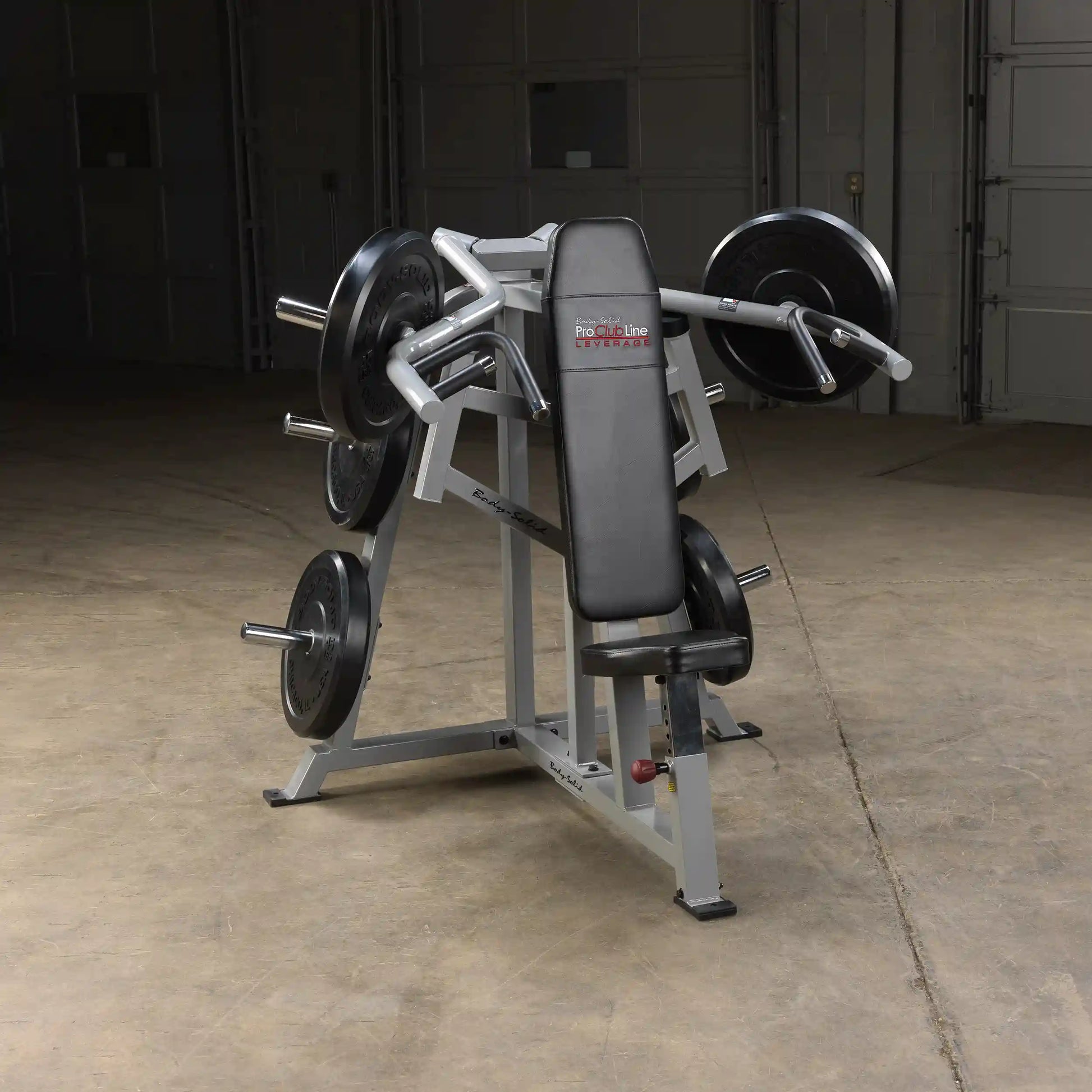 Body-Solid Pro ClubLine Leverage Shoulder Press Machine LVSP positioned in a gym environment with weights attached.