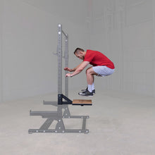 A person performing a jump exercise on the Body-Solid Pro ClubLine Plyo Step Attachment SPRSTEP, showcasing the equipment's use in a fitness setting.