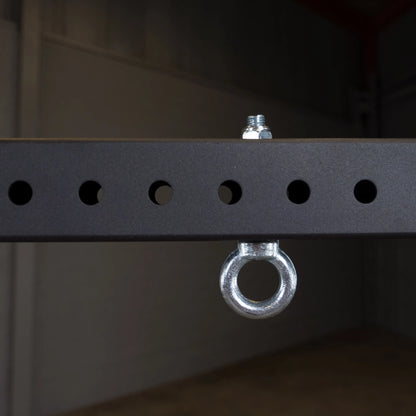 Close-up image of a metal connecting bar featuring evenly spaced round holes and an attached circular metal ring, part of the Body-Solid Pro ClubLine Power Rack Connecting Bar SPRACB.