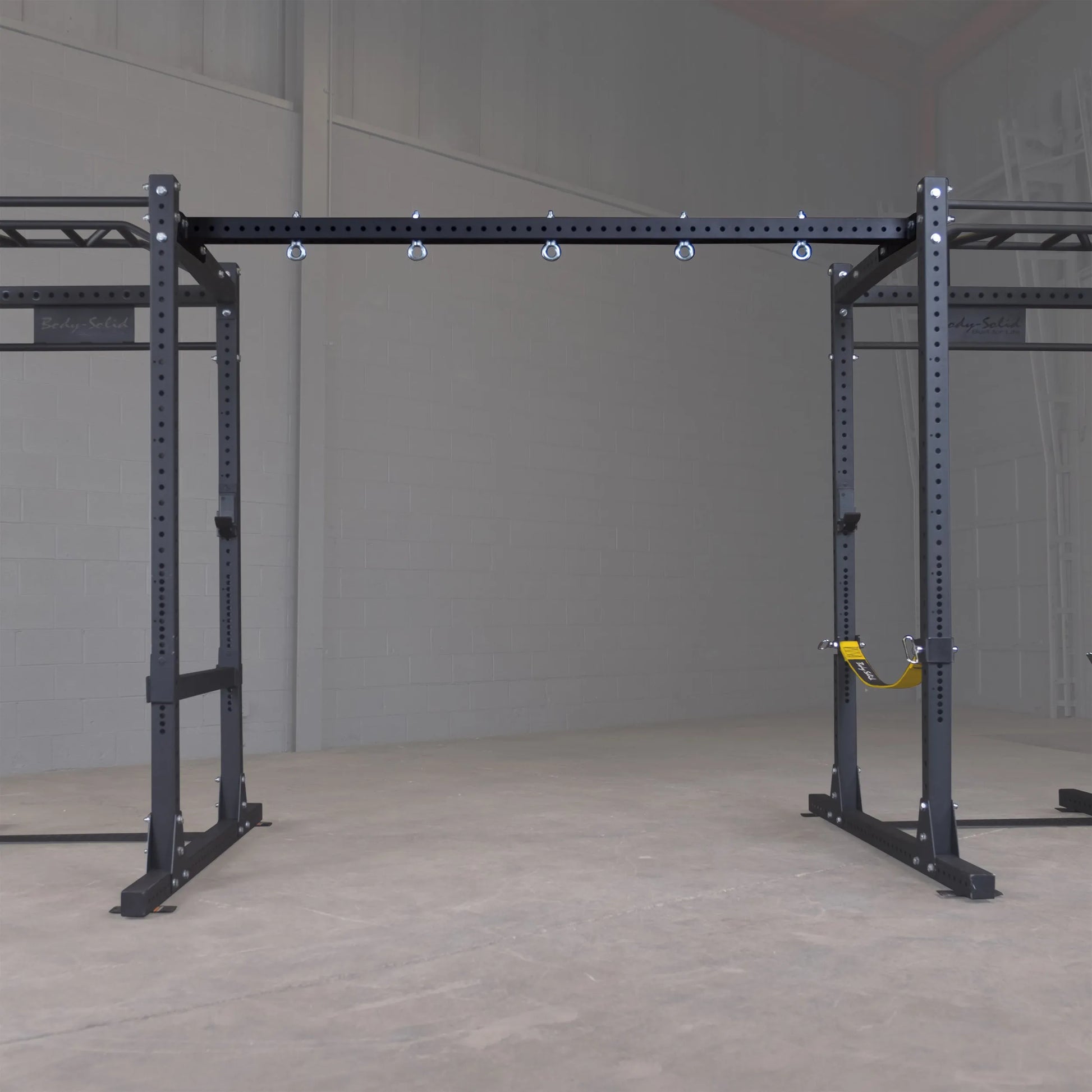 Body-Solid Pro ClubLine Power Rack with Connecting Bar SPRACB in a gym setting.