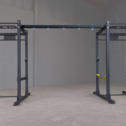 Body-Solid Pro ClubLine Power Rack with Connecting Bar SPRACB in a gym setting.