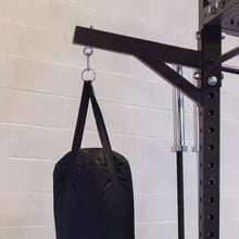 Body-Solid Pro ClubLine Power Rack Heavy Bag Hanger SPRHBH holding a black heavy bag, mounted on a sturdy rack against a light gray wall.