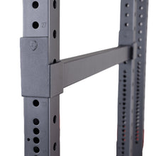 Close-up view of the Body-Solid Pro ClubLine Premium Safeties SPRSF, showcasing the adjustable safety bar and numbered holes on the rack.