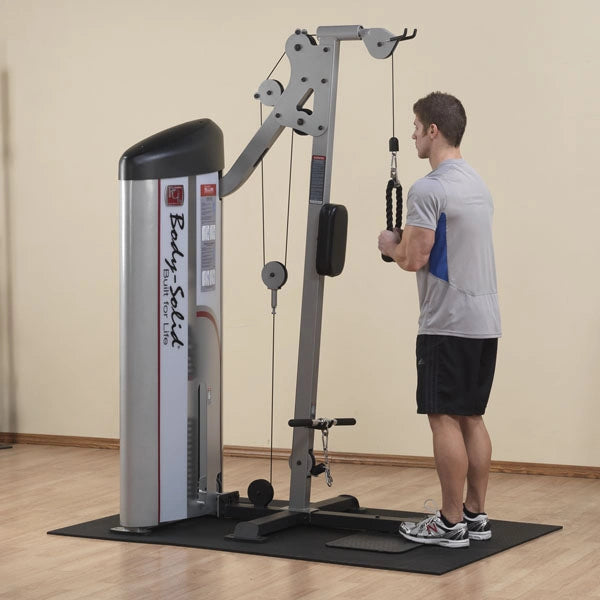 A man using the Body-Solid Pro ClubLine Series 2 Bicep & Tricep Machine S2BTP in a gym setting, performing a tricep exercise.