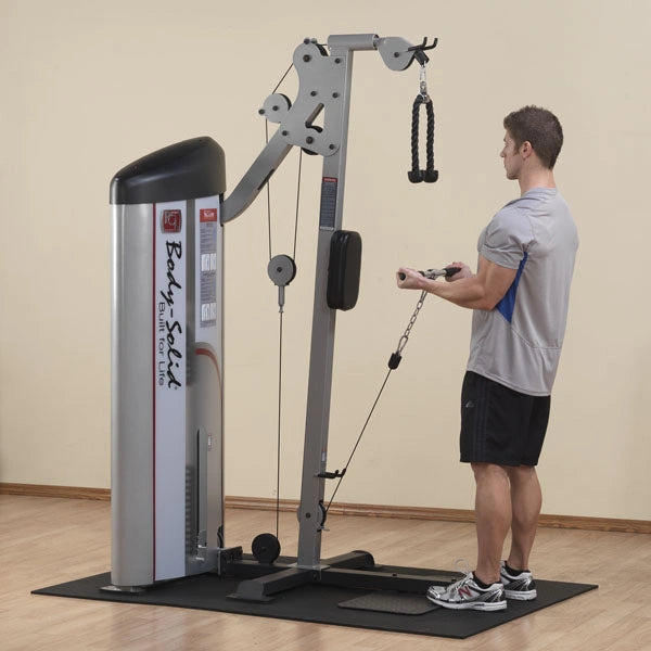 A man using the Body-Solid Pro ClubLine Series 2 Bicep & Tricep Machine S2BTP in a gym setting, performing a tricep extension exercise.