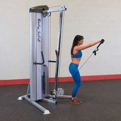 A woman in a blue workout outfit using the Body-Solid Pro ClubLine Series 2 Cable Column S2CC in a gym setting, performing an exercise with a cable attachment.