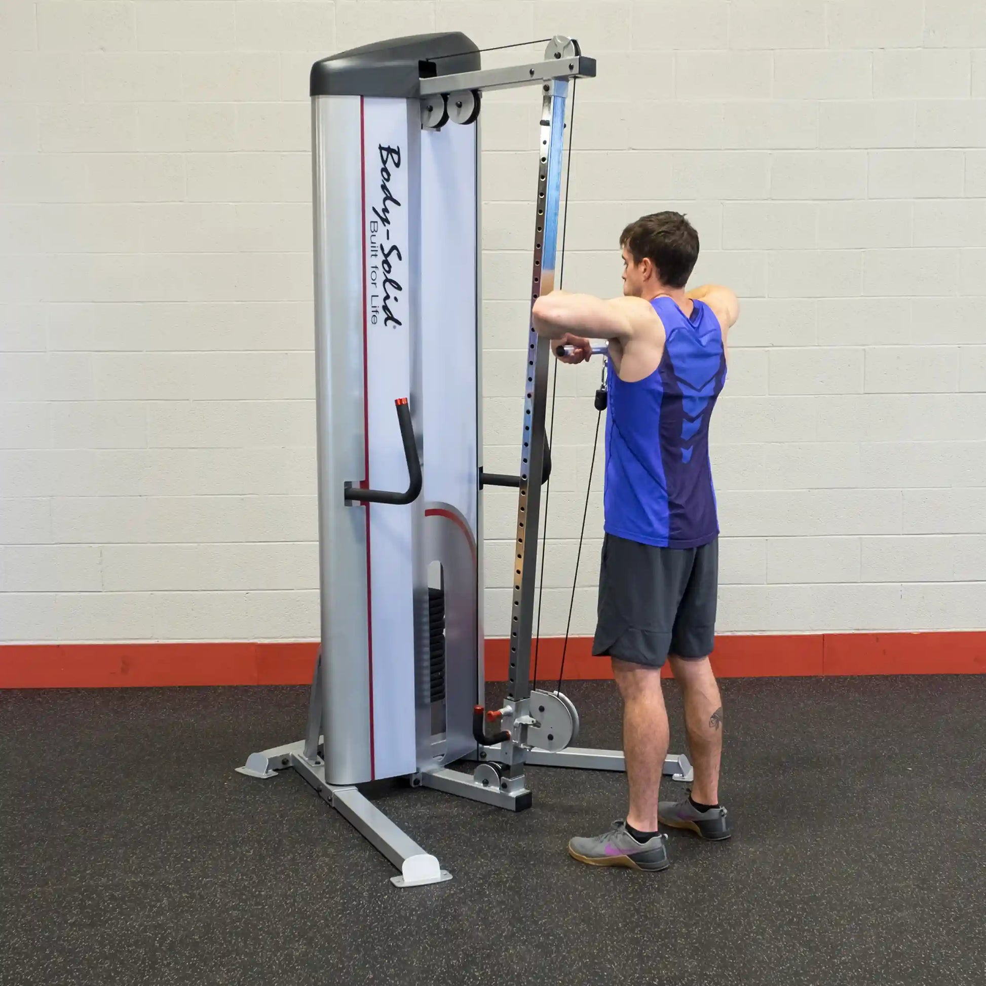 A person using the Body-Solid Pro ClubLine Series 2 Cable Column S2CC for exercise in a gym setting, focusing on strength training.