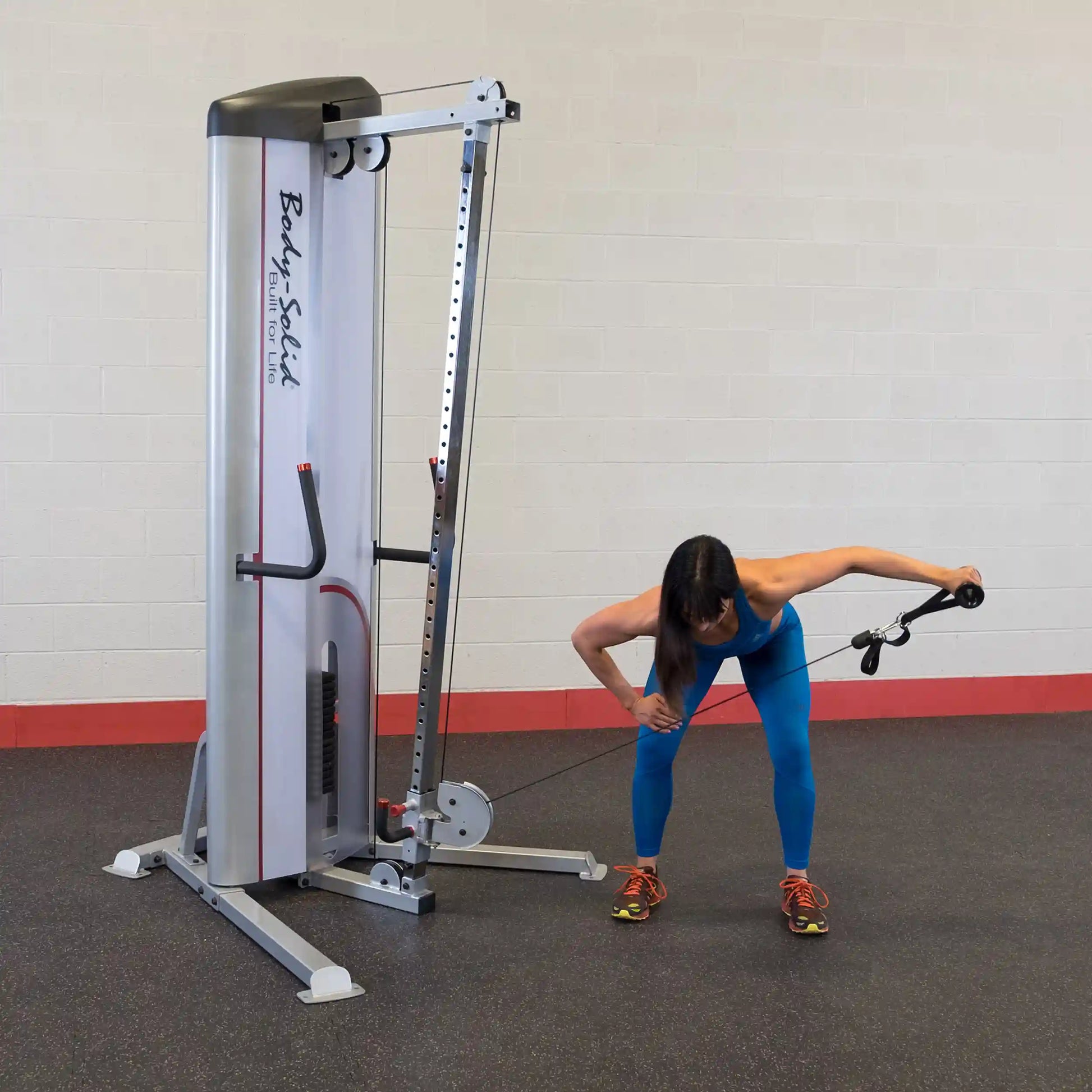 A woman performing a cable exercise using the Body-Solid Pro ClubLine Series 2 Cable Column S2CC in a gym setting.