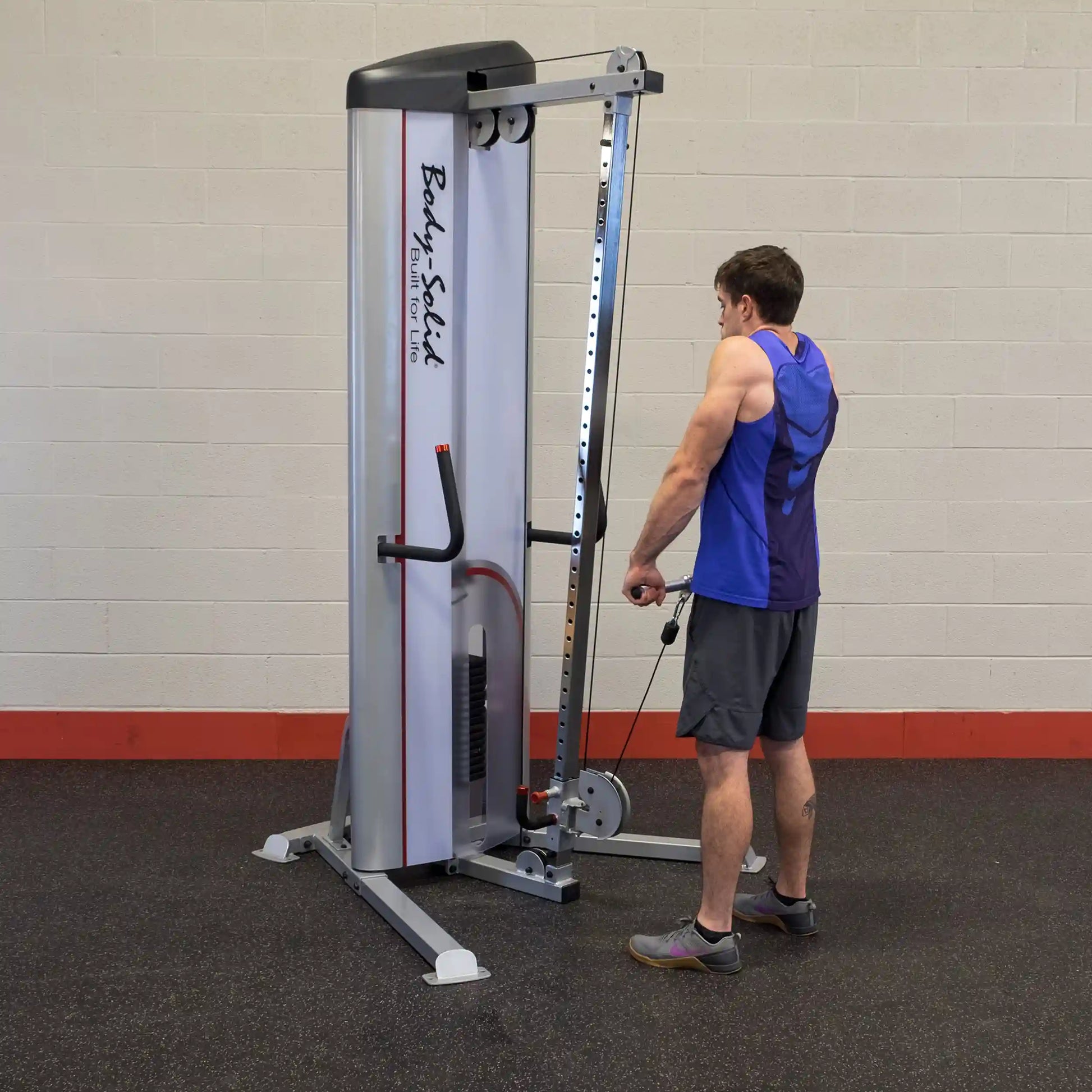 A person using the Body-Solid Pro ClubLine Series 2 Cable Column S2CC for strength training in a gym setting.