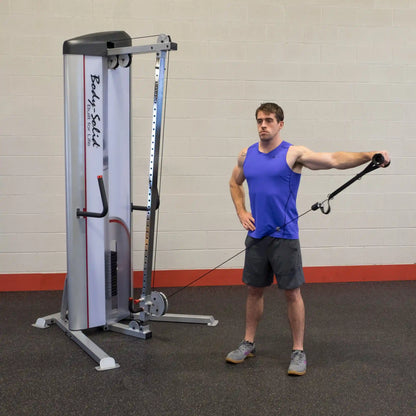 A man demonstrating an exercise using the Body-Solid Pro ClubLine Series 2 Cable Column S2CC, standing with one arm extended while holding the cable attachment.