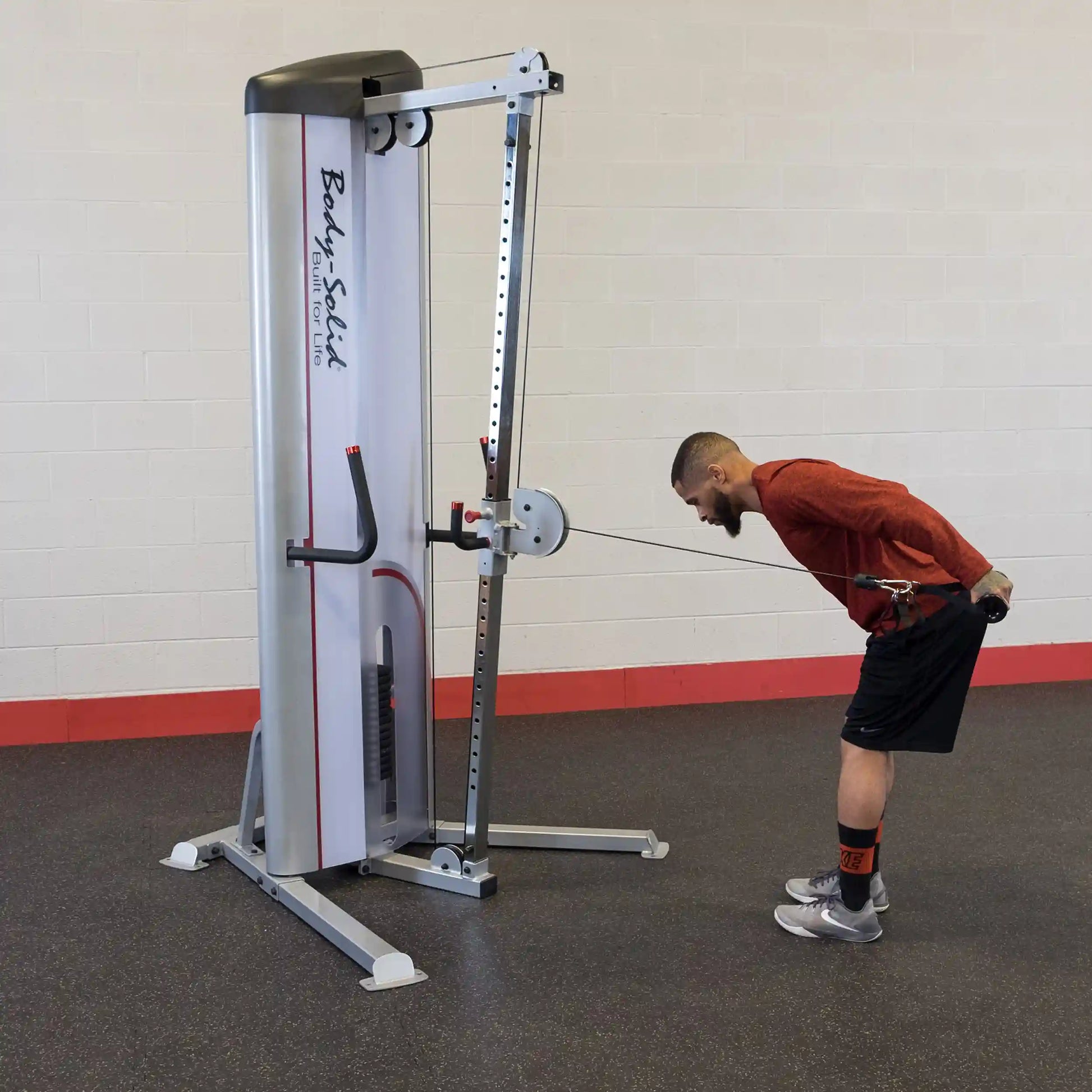 A person performing a cable row exercise using the Body-Solid Pro ClubLine Series 2 Cable Column S2CC in a gym setting.