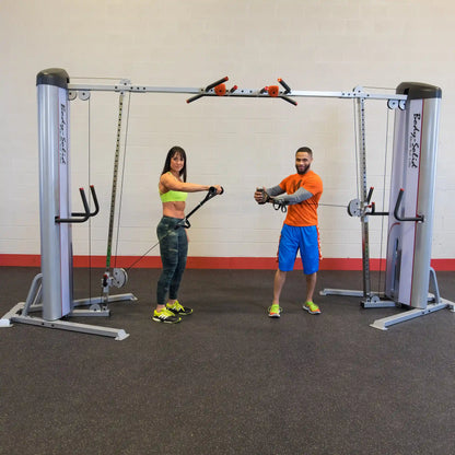 Two individuals demonstrating exercises on the Body-Solid Pro ClubLine Series 2 Cable Crossover S2CCO in a gym setting.