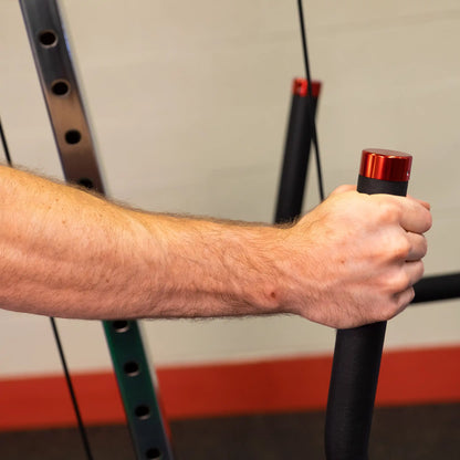 Close-up of a hand gripping the handle of the Body-Solid Pro ClubLine Series 2 Cable Crossover S2CCO, showcasing the equipment's design and functionality.