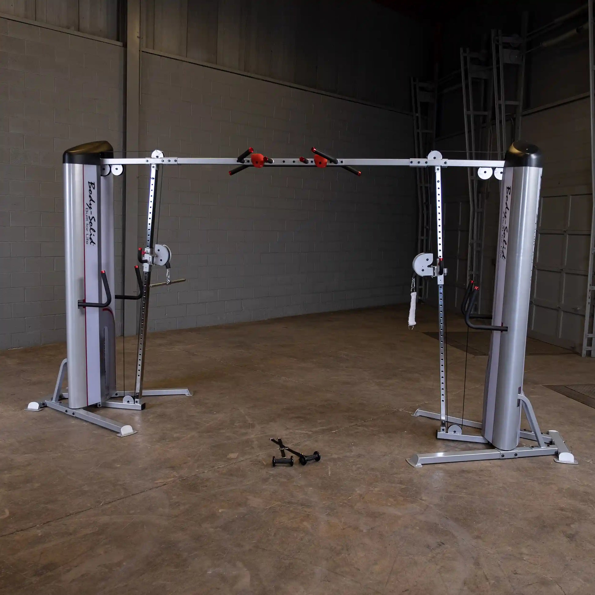 Body-Solid Pro ClubLine Series 2 Cable Crossover S2CCO, featuring dual vertical posts with adjustable pulleys and handles, set in a spacious gym environment.