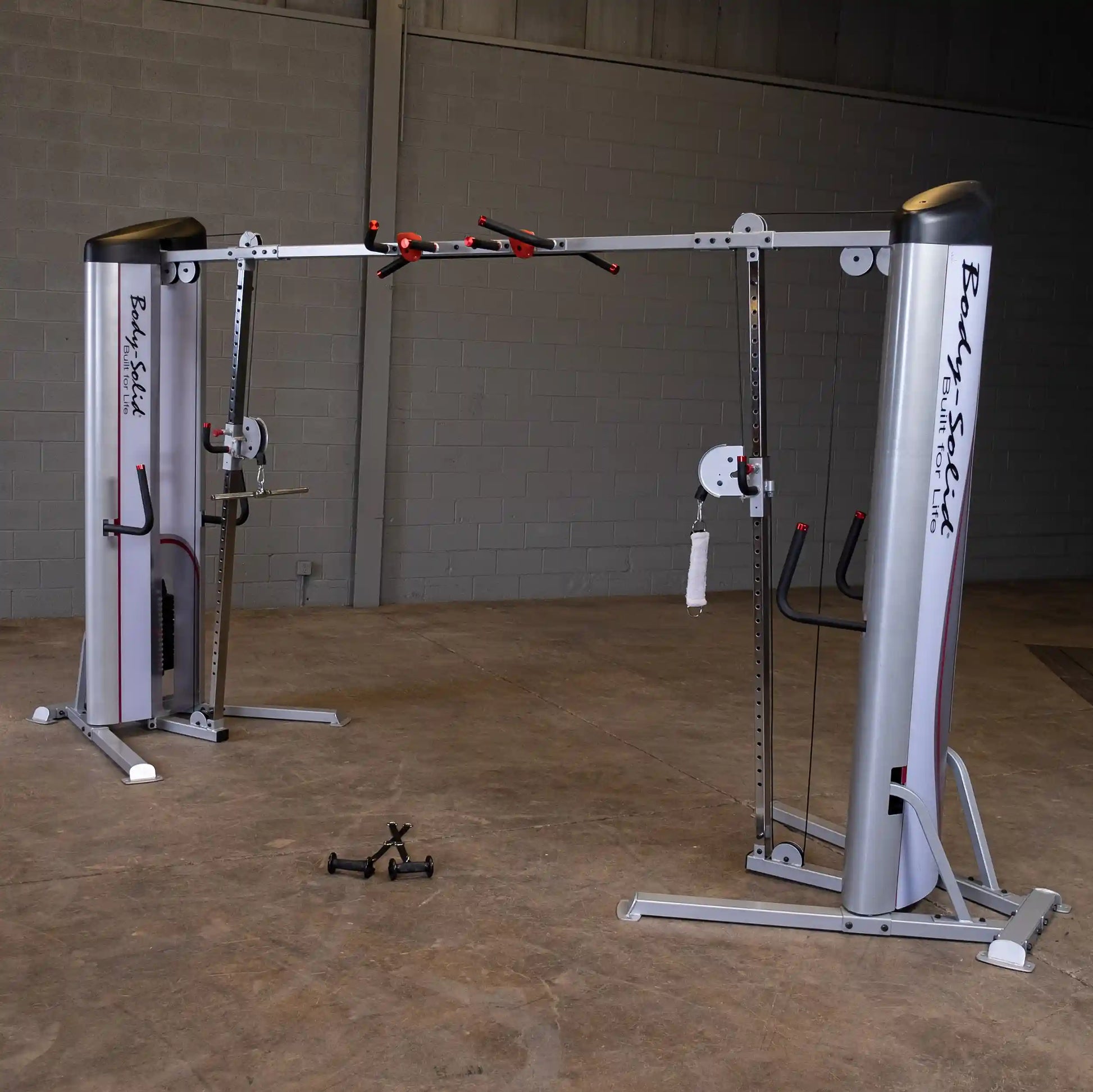 Image of the Body-Solid Pro ClubLine Series 2 Cable Crossover S2CCO, featuring dual cable stations and adjustable pulleys, set in a gym environment with a concrete floor.