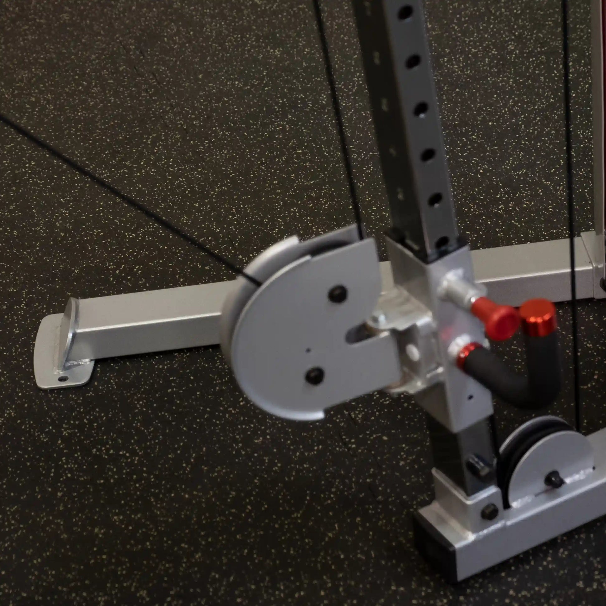 Close-up view of the Body-Solid Pro ClubLine Series 2 Cable Crossover S2CCO, highlighting the pulleys and cable system on a gym floor.