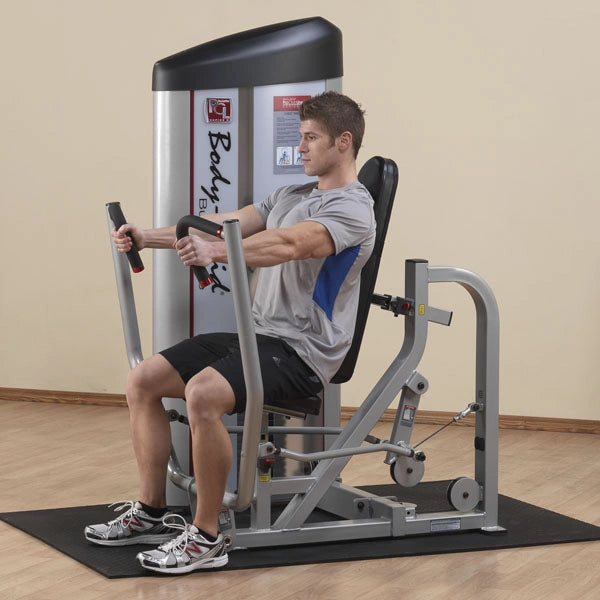 A person using the Body-Solid Pro ClubLine Series 2 Chest Press Machine S2CP, performing a chest press exercise in a gym setting.