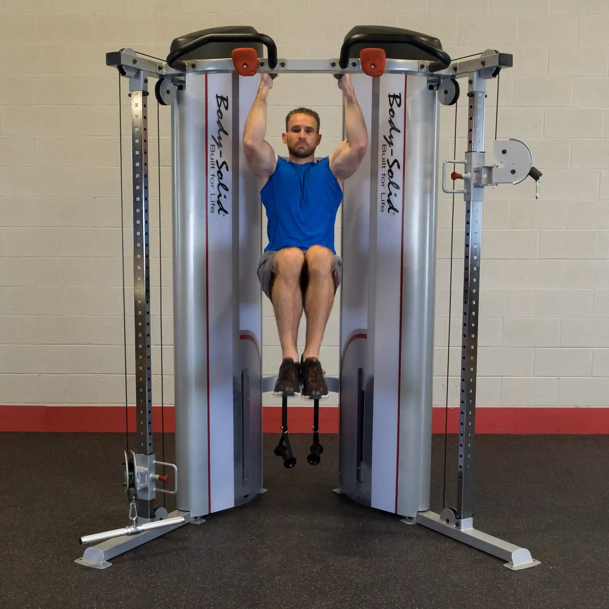 Man performing an exercise on the Body-Solid Pro ClubLine Series 2 Functional Trainer S2FT, showcasing strength training in a gym setting.