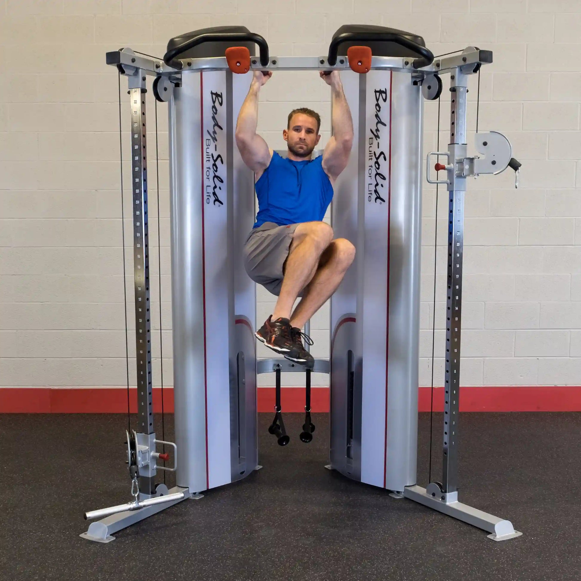 A person performing an exercise using the Body-Solid Pro ClubLine Series 2 Functional Trainer S2FT, showcasing a workout setup in a gym environment.