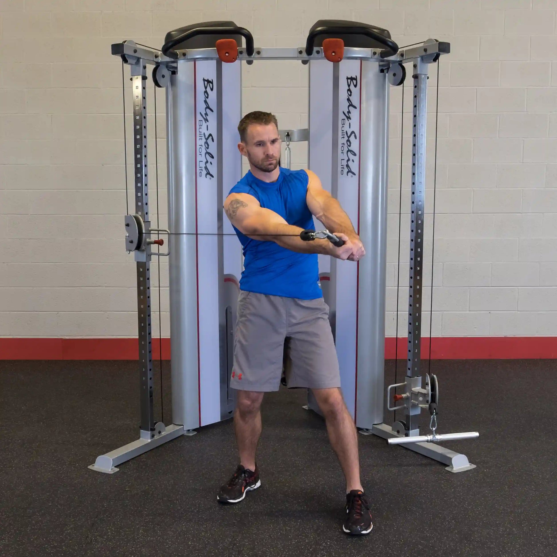 A man performing an exercise on the Body-Solid Pro ClubLine Series 2 Functional Trainer S2FT in a gym setting.