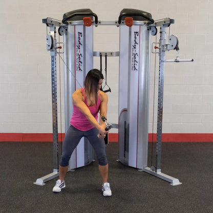 A woman performing an exercise using the Body-Solid Pro ClubLine Series 2 Functional Trainer S2FT, demonstrating a functional training movement in a gym setting.