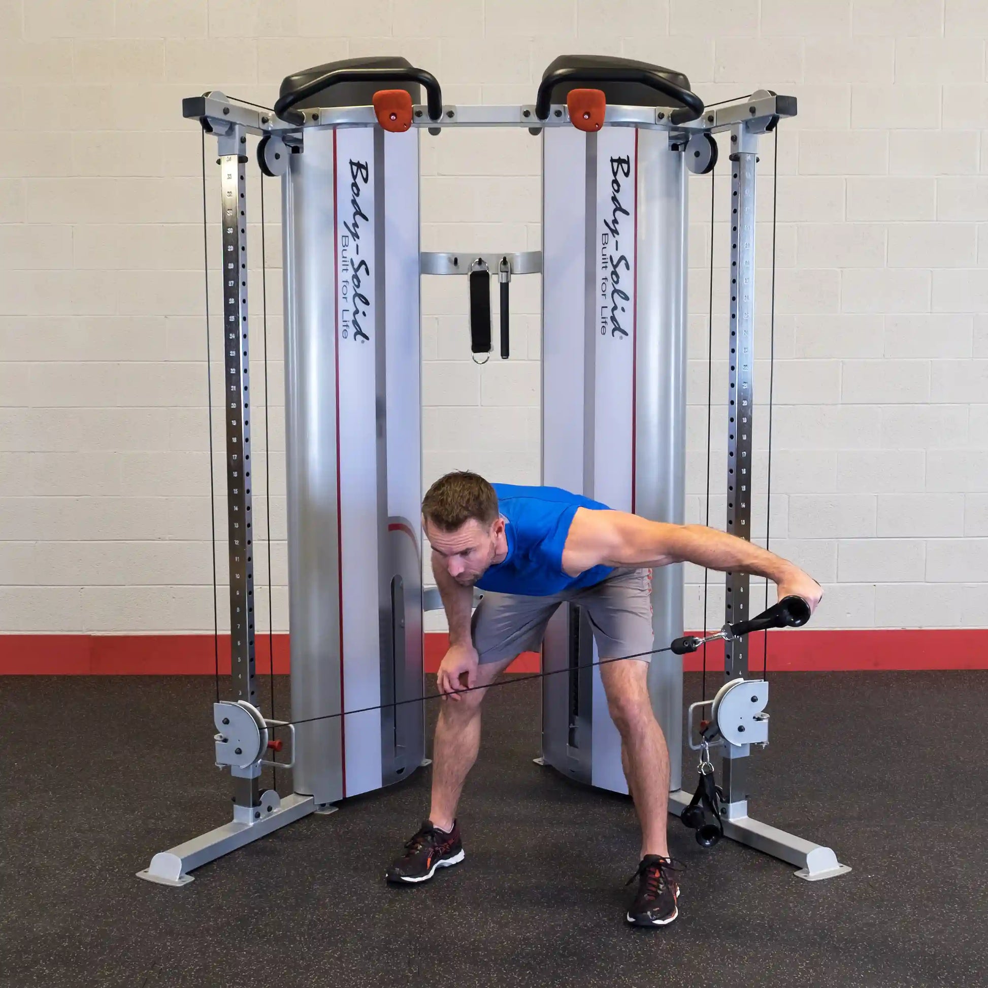 A person demonstrating an exercise using the Body-Solid Pro ClubLine Series 2 Functional Trainer S2FT, with a focus on proper form and technique.