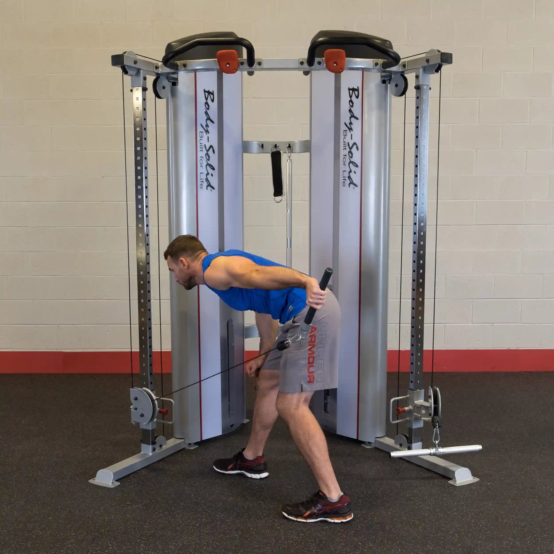 A person performing a bent-over row exercise using the Body-Solid Pro ClubLine Series 2 Functional Trainer S2FT in a gym setting.